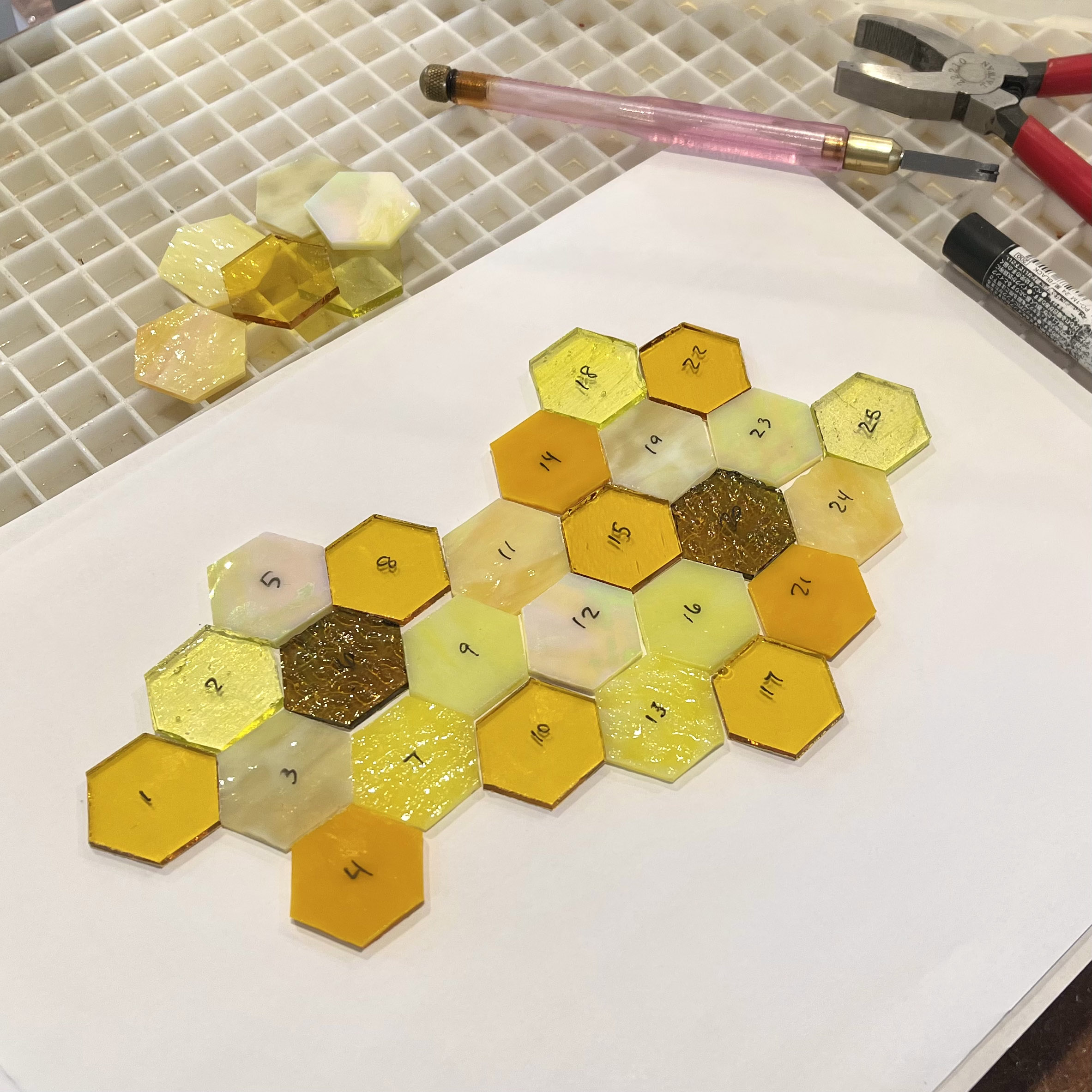 Cut stained glass pieces laid out before copper foiling