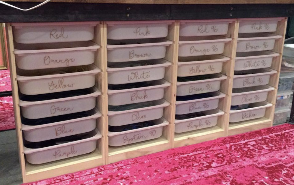 IKEA Trofast bins sorted by glass scrap color with custom vinyl labels.